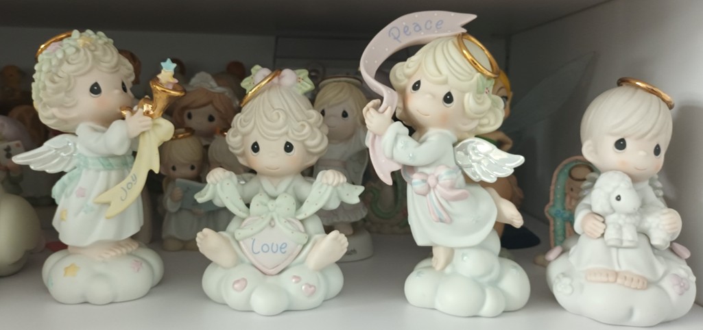 A set of three heavenly angels and an angel holding a sheep.